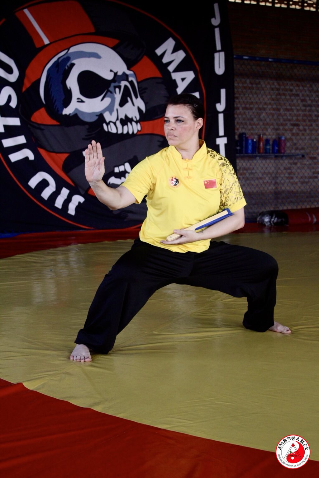 Atleta treinando rotina de Taolu com leque